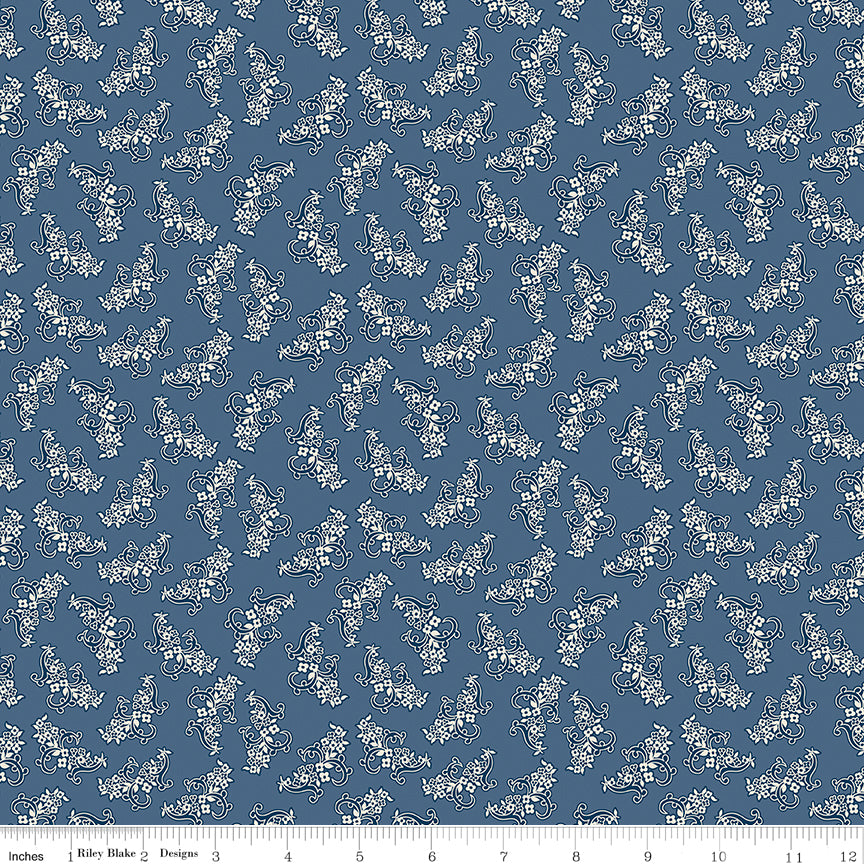 Blue fabric with pixelated flowers made from tiny X's.