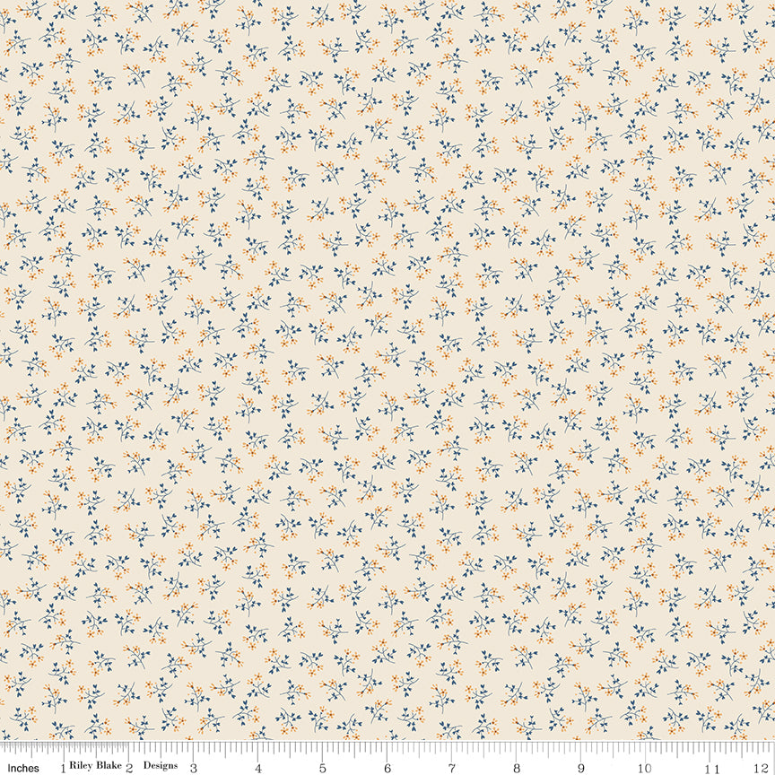 Blue fabric with scattered sprigs of flowers.