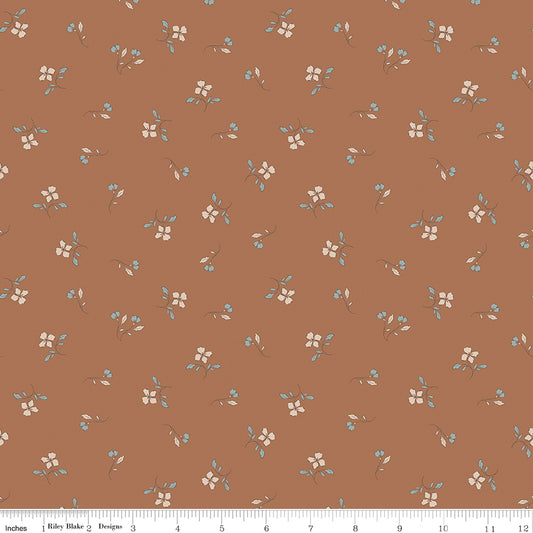 Red fabric with scattered sprigs of flowers and leaves.