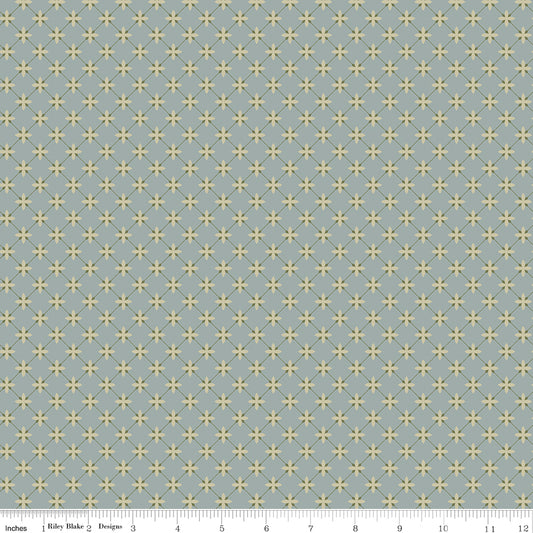 Blue fabric with a lattice grid with petals at the intersections.