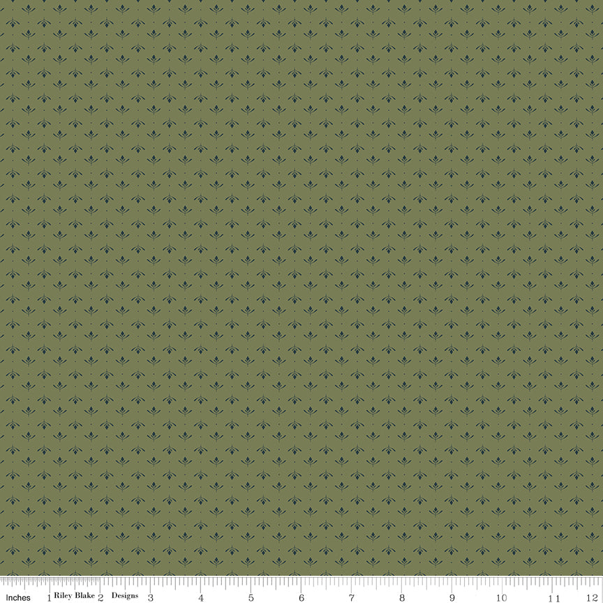 Green fabric with an array of blossoms and pin dots.