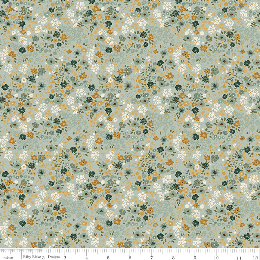 Sage laurel green quilting cotton fabric with an all-over meadow floral print in white, golden yellow, and forest green. Worth Repeating by Sandy Gervais for Riley Blake Designs.