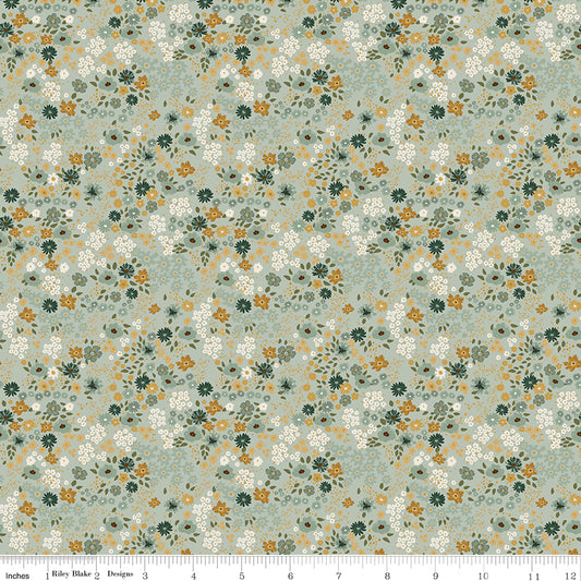 Sage laurel green quilting cotton fabric with an all-over meadow floral print in white, golden yellow, and forest green. Worth Repeating by Sandy Gervais for Riley Blake Designs.