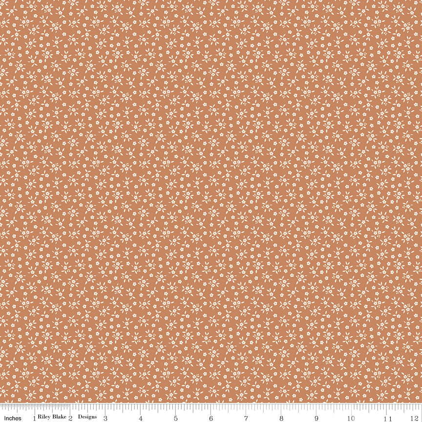 Warm terracotta quilting cotton fabric with an all-over tiny ditsy floral and leaf print in cream. Worth Repeating by Sandy Gervais for Riley Blake Designs.