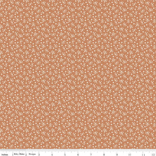 Warm terracotta quilting cotton fabric with an all-over tiny ditsy floral and leaf print in cream. Worth Repeating by Sandy Gervais for Riley Blake Designs.