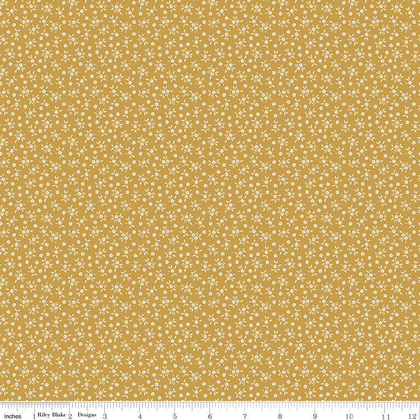 Golden mustard quilting cotton fabric with an all-over tiny ditsy floral and leaf print in cream. Worth Repeating by Sandy Gervais for Riley Blake Designs.