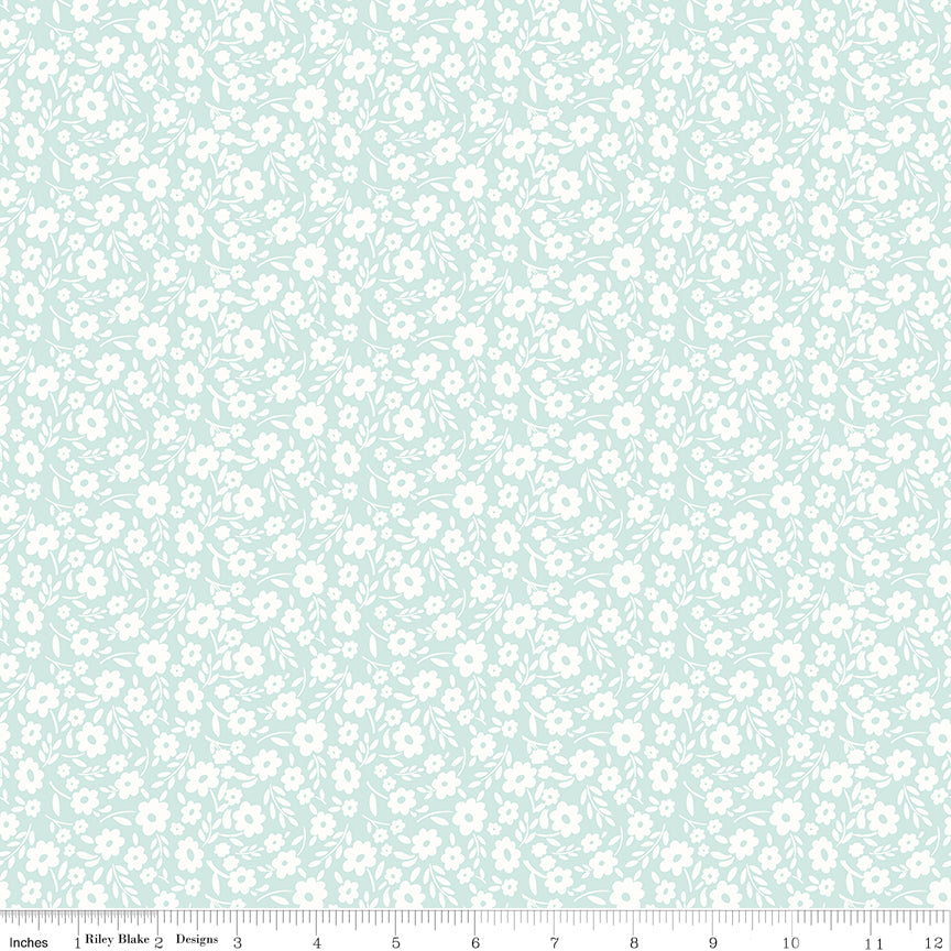Aqua fabric with white sprigs of flowers.