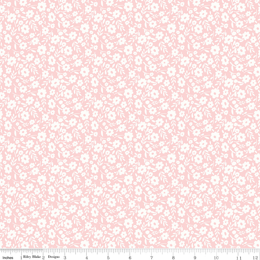 Pink fabric with white sprigs of flowers.