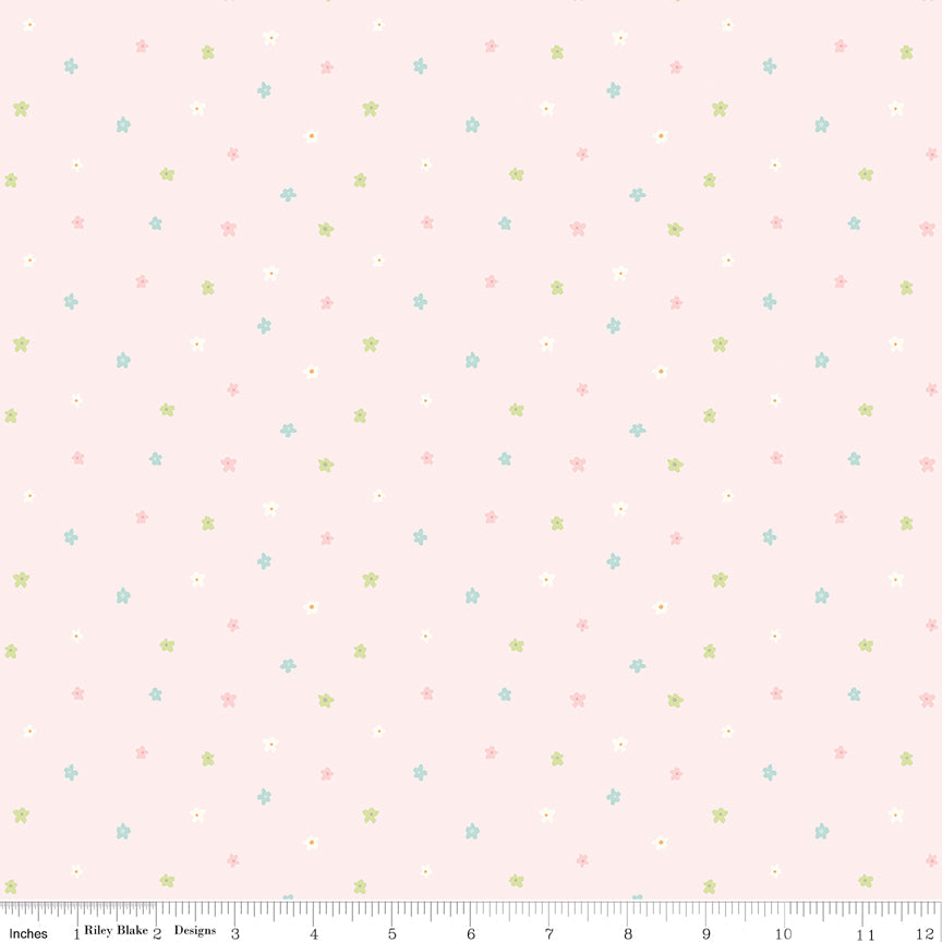 Pink fabric with scattered little blossoms.