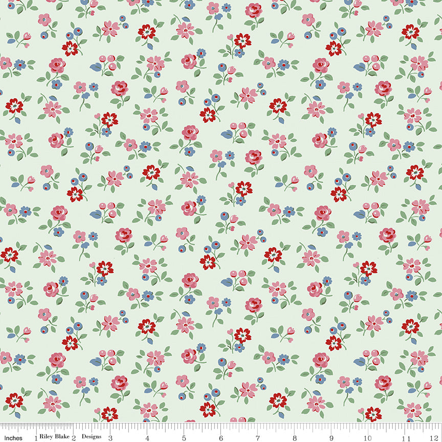 This print features sprigs of flowers and leaves on a pale mist background.