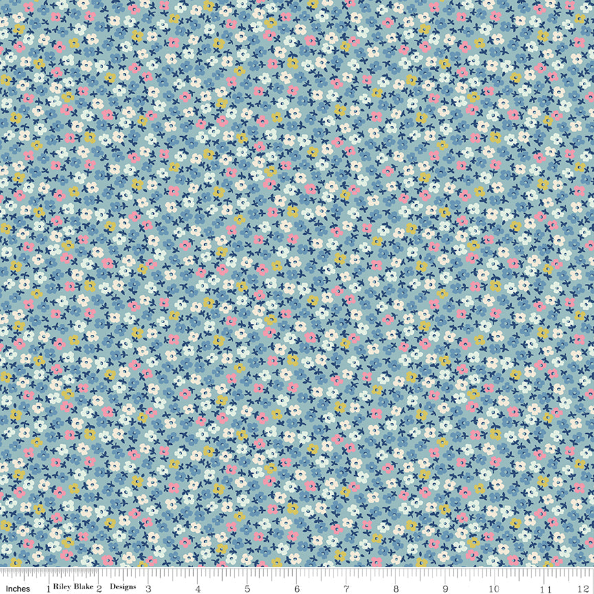 Fabric swatch with scattered pink, white, yellow and blue flowers on a light blue background.