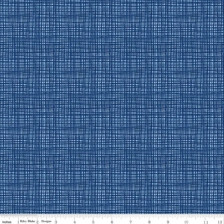 Blue fabric with a tone-on-tone sketched irregular grid, with a ruler along the bottom edge.