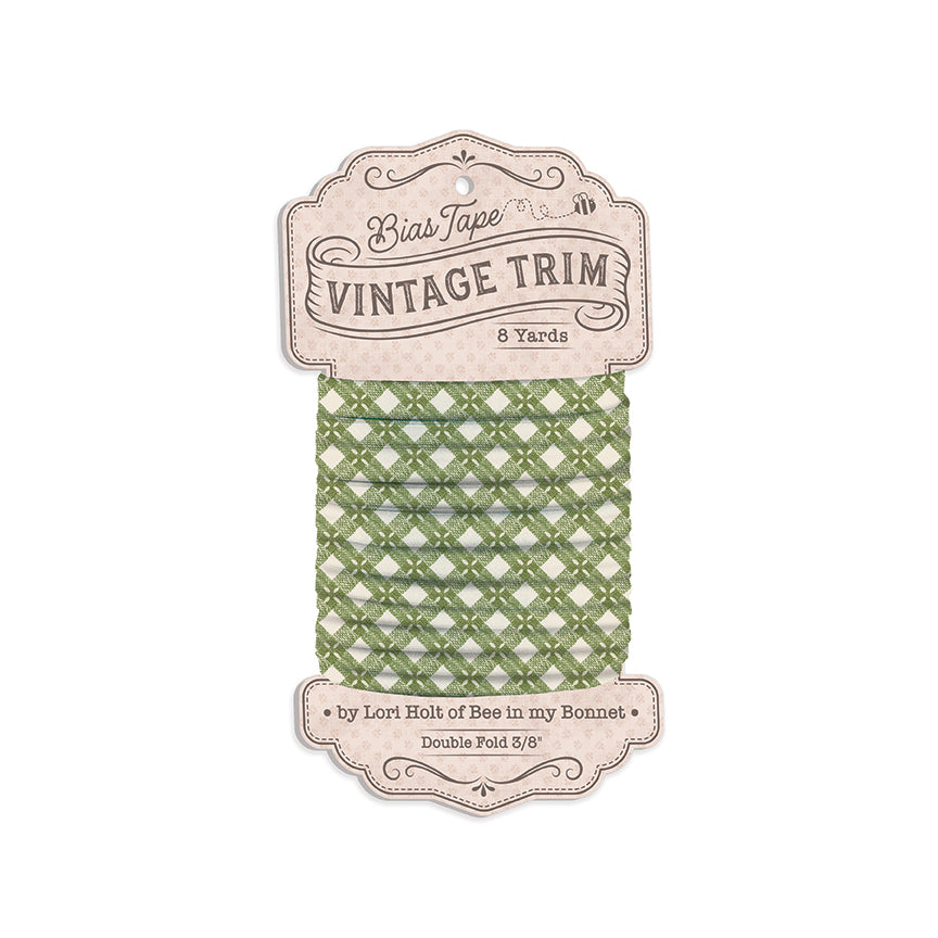 A package of Bias Tape Vintage Trim featuring sage green lattice-patterned tape wound around a cardboard spool, with decorative vintage-style labels at the top and bottom.