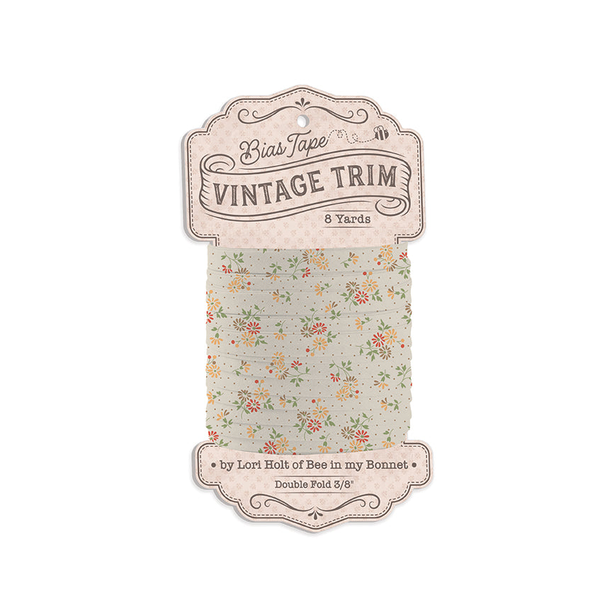 Bias Tape Vintage Trim in a floral pattern on a light sage green background, packaged on a vintage-style paper hanger card.