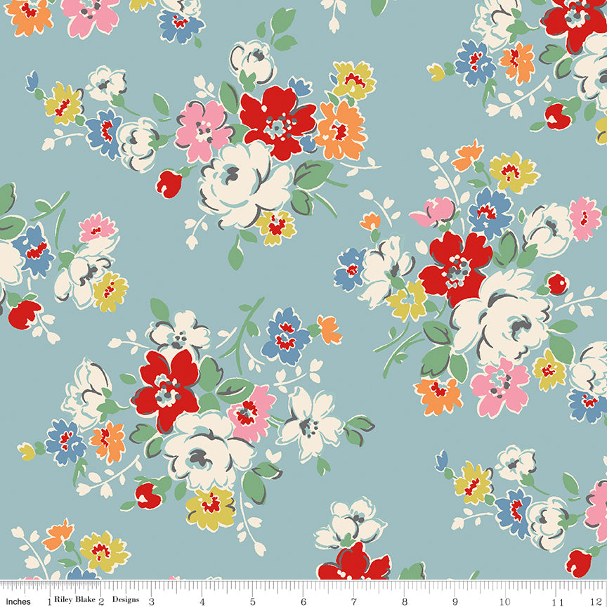Blue wide back fabric with Clifton Rose floral bouquets, shown with a ruler along the bottom edge.